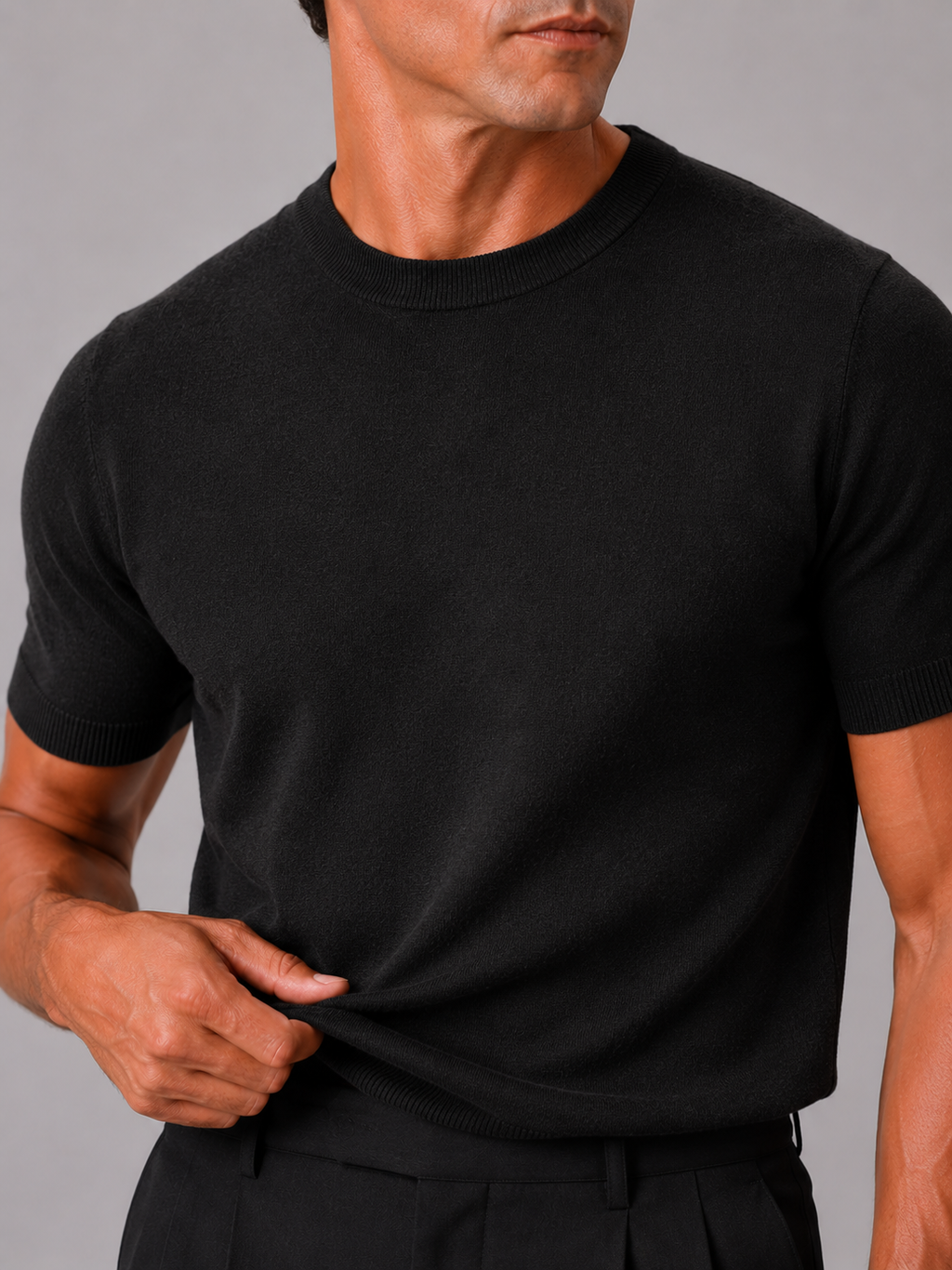 Close up of black knit t shirt showing soft breathable texture and clean crew neck detail