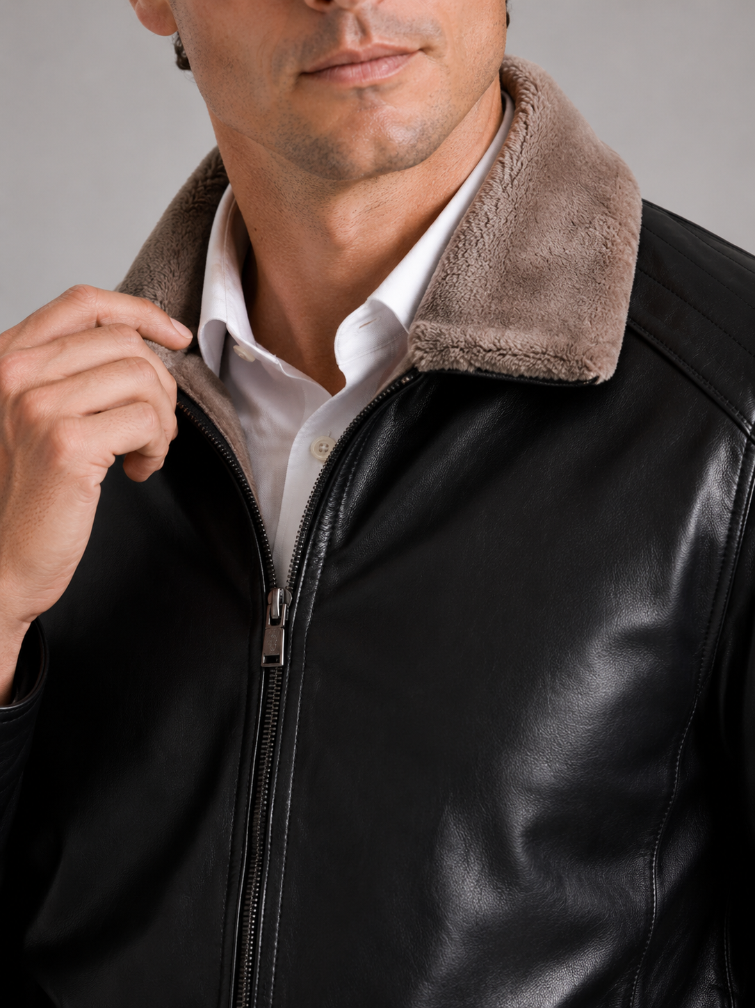 Close up of black leather biker jacket showing smooth leather texture and soft fleece lining detail