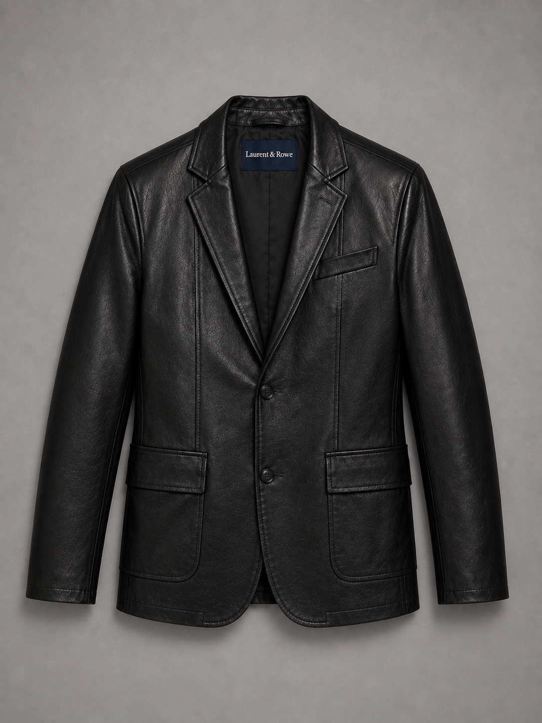 Black men’s leather blazer jacket with a slim fit and classic lapel displayed on a plain background