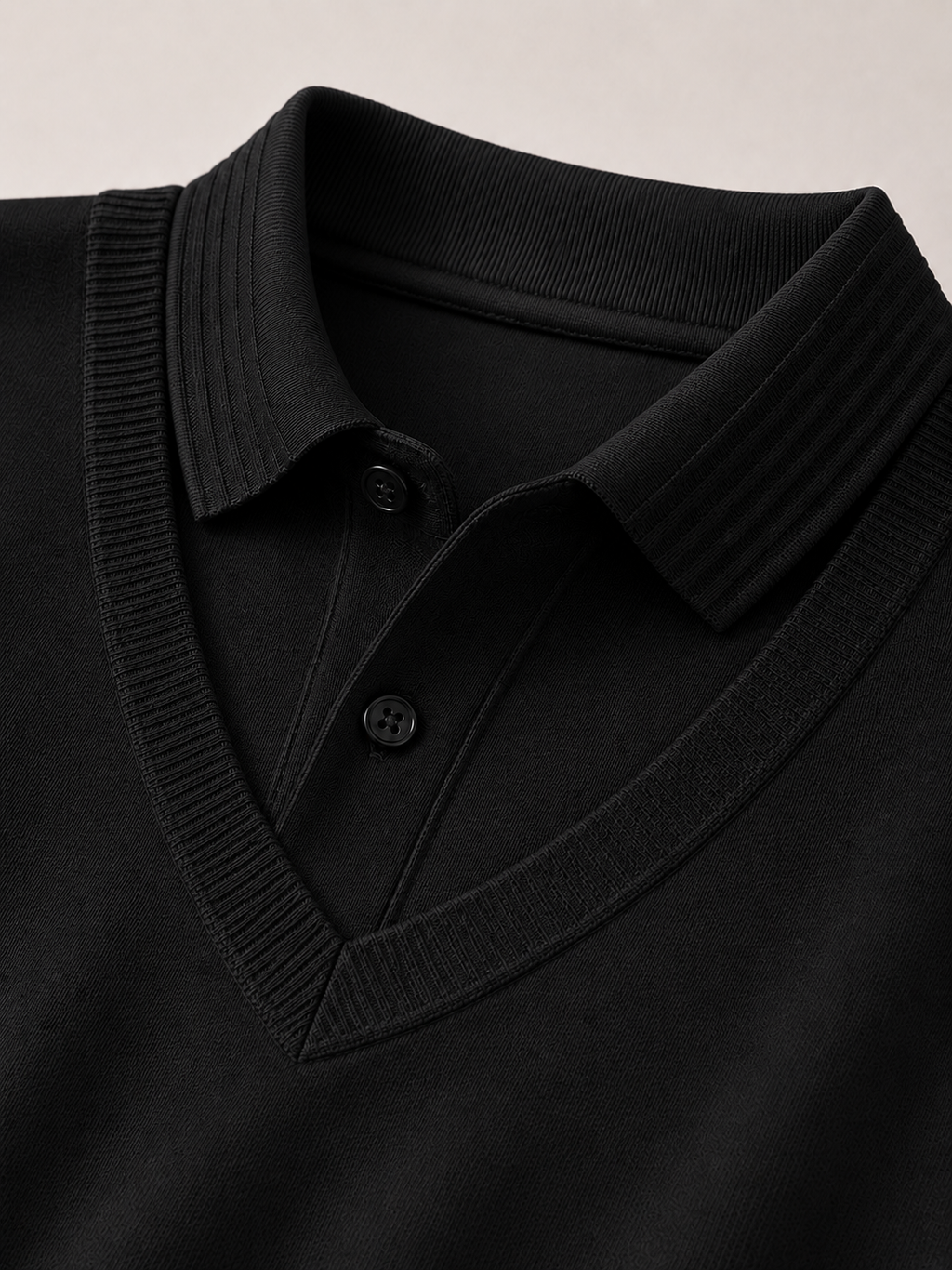 Close up of black polo shirt showing soft lightweight fabric and refined collar detail