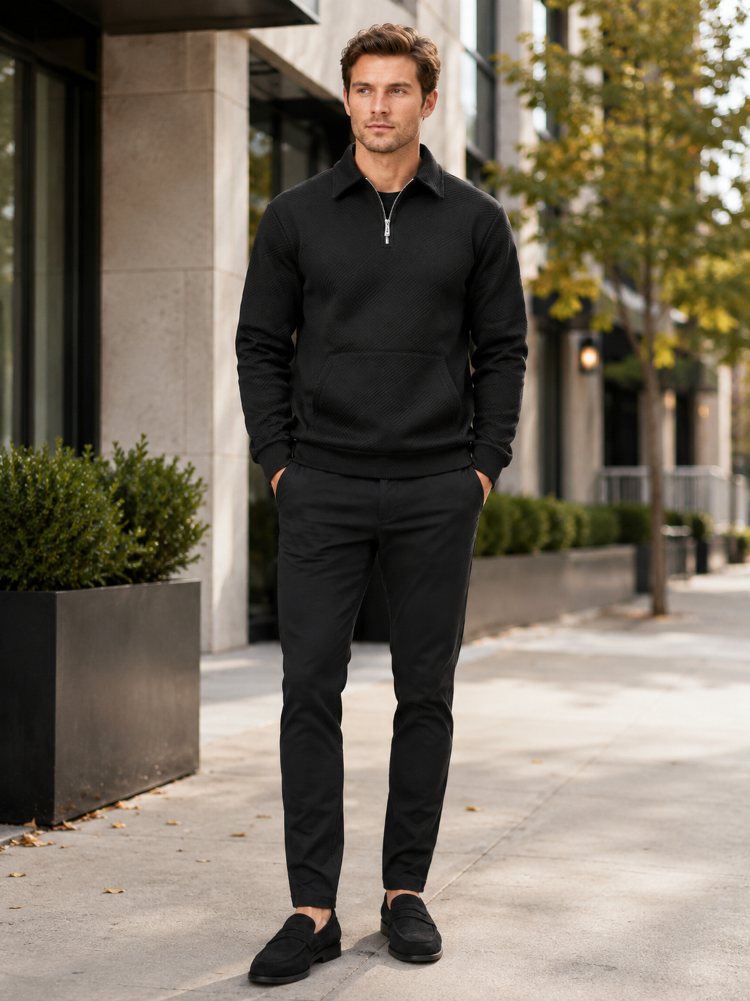 Man styling black quarter zip sweater in a modern outdoor and everyday lifestyle outfit