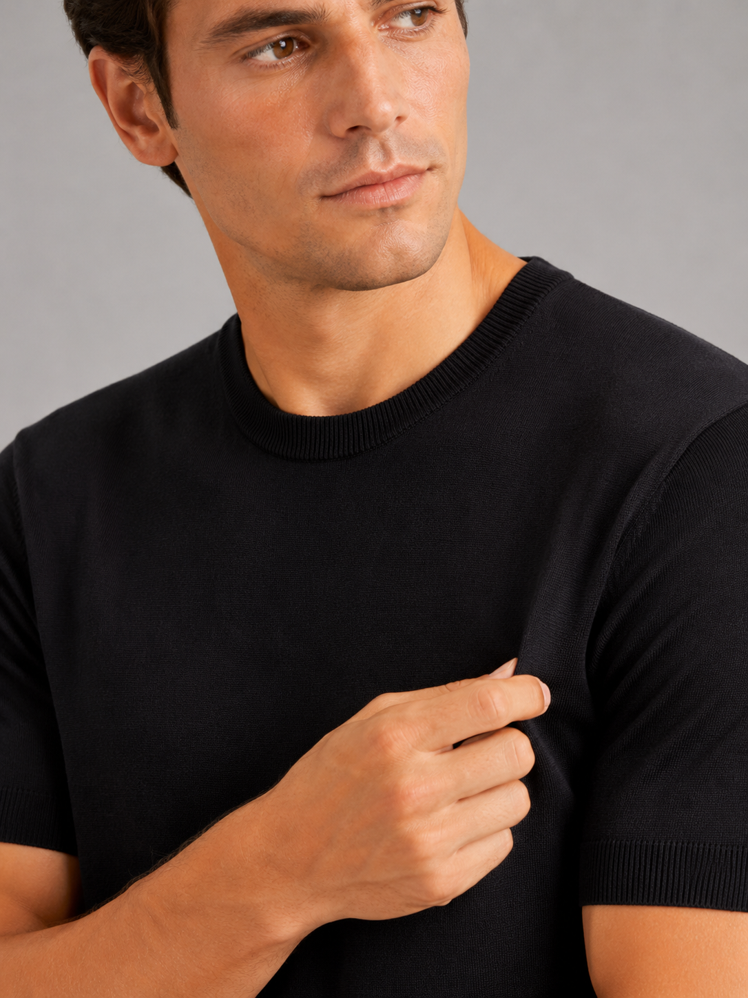 Close up of black merino wool knit t shirt showing soft breathable texture and crew neck detail