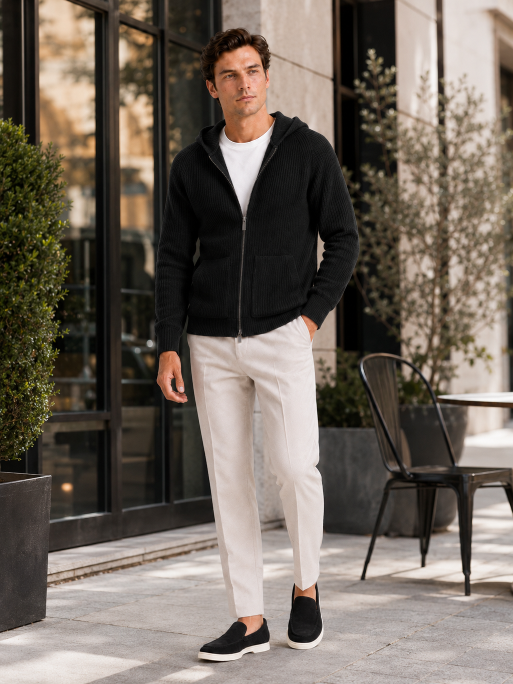 Man styling black merino wool zip hoodie cardigan in a sleek fall winter lifestyle outfit