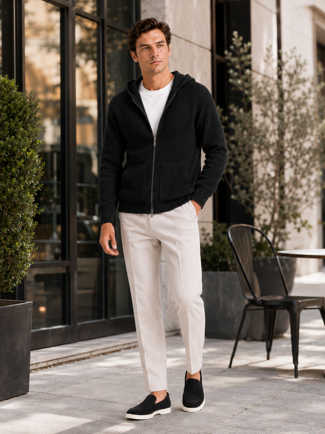 Man styling black merino wool zip hoodie cardigan in a sleek fall winter lifestyle outfit