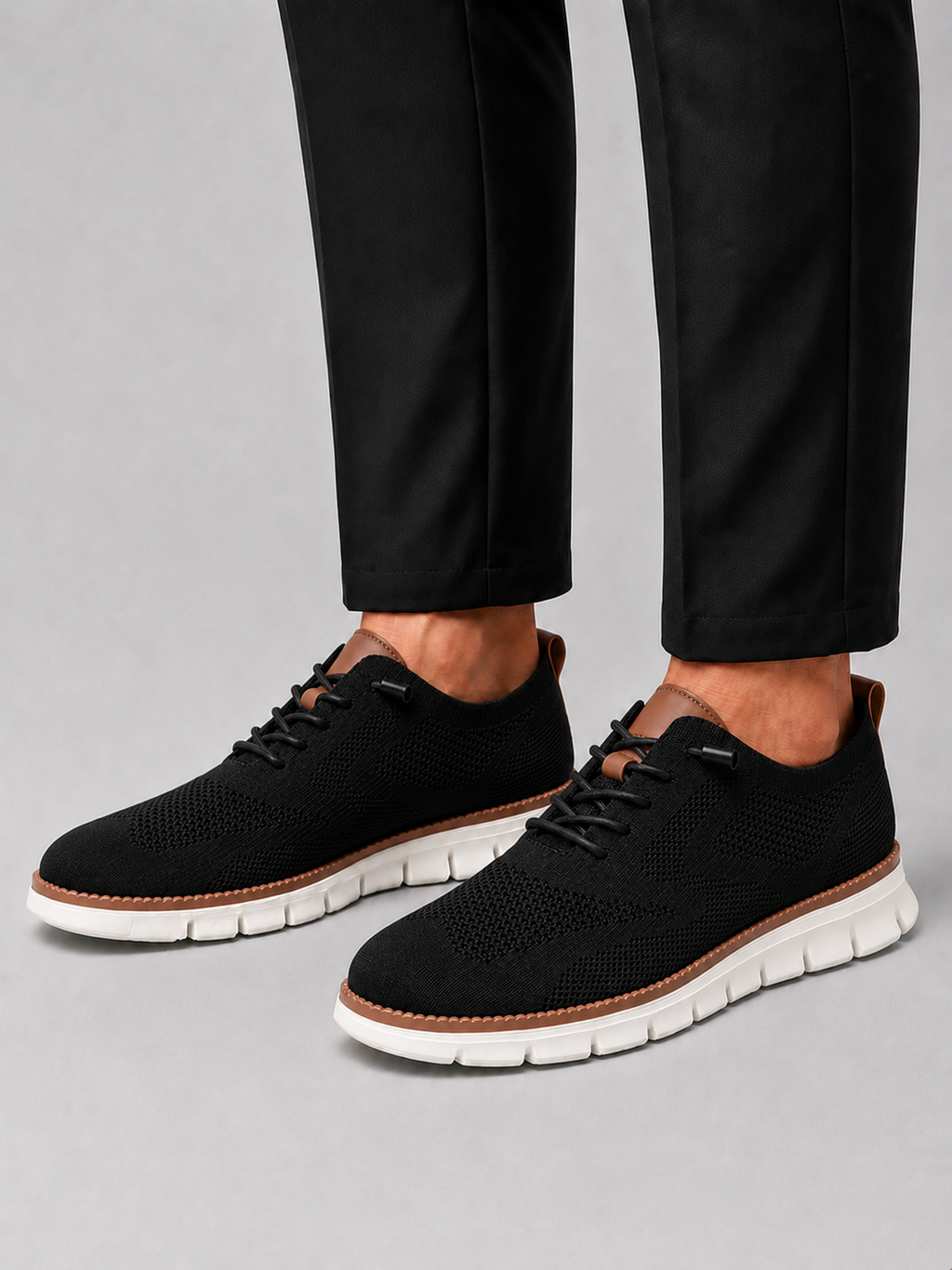 Man styling black mesh sneakers in a modern summer travel and everyday lifestyle outfit