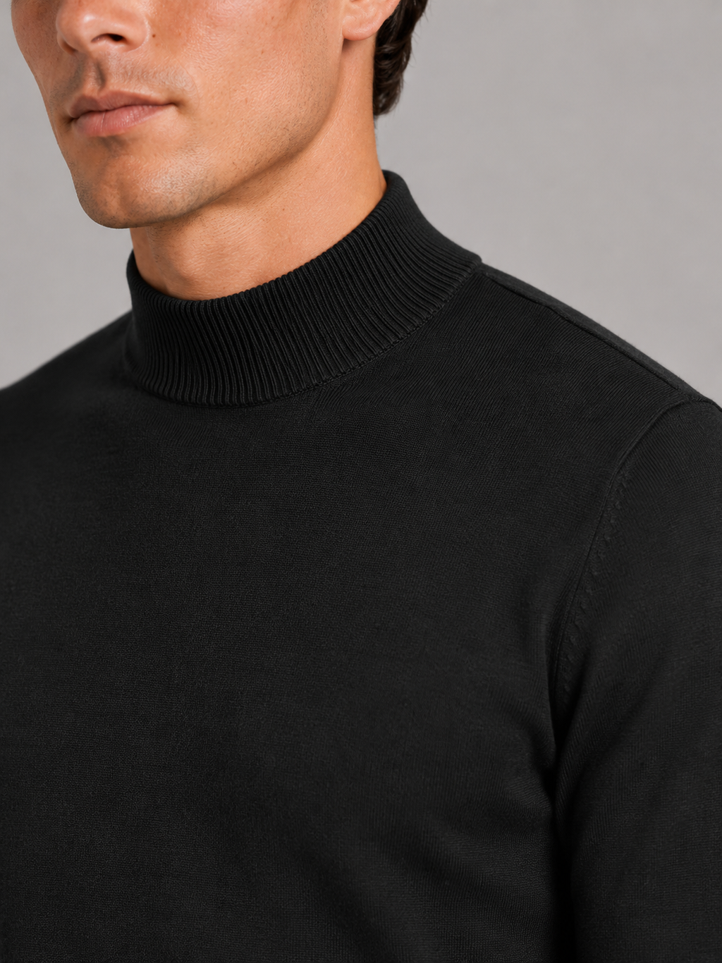 Close up of black mock neck sweater showing soft knit texture and refined collar detail