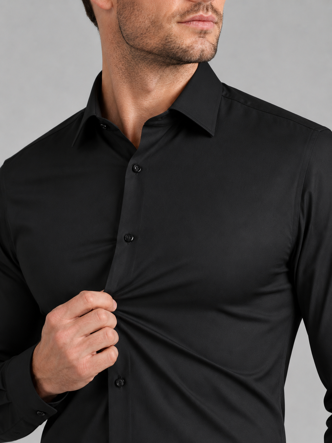 Close up of black dress shirt showing wrinkle resistant stretch fabric and crisp collar detail