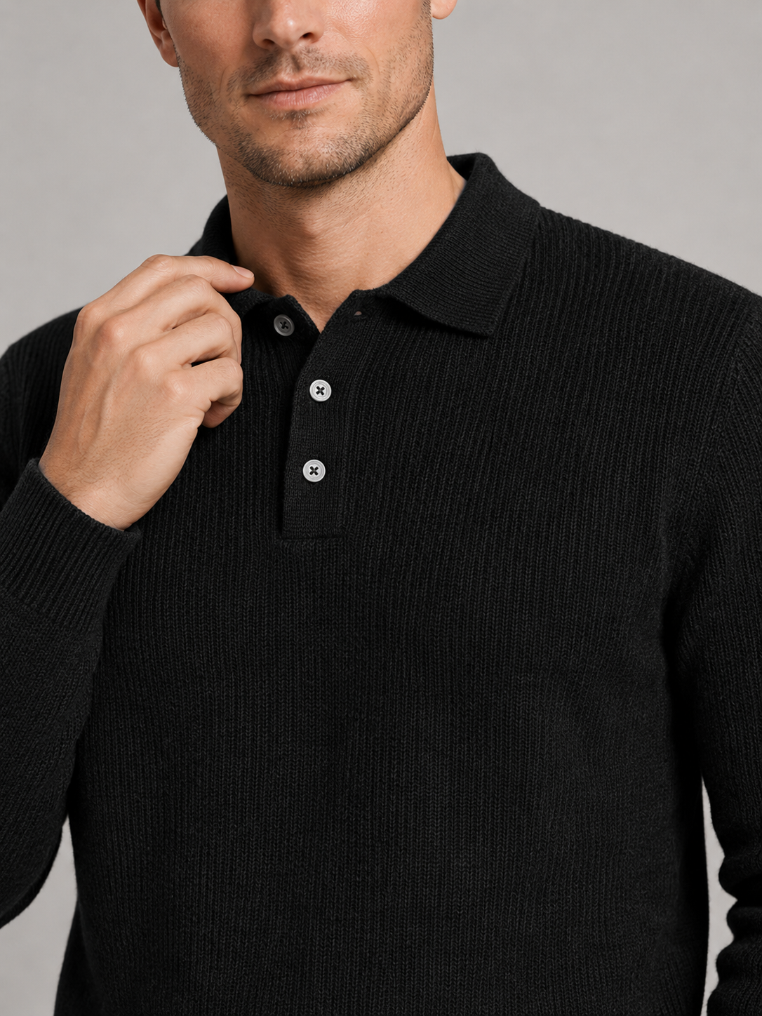 Close up of black polo neck sweater showing soft knit texture and refined high collar detail