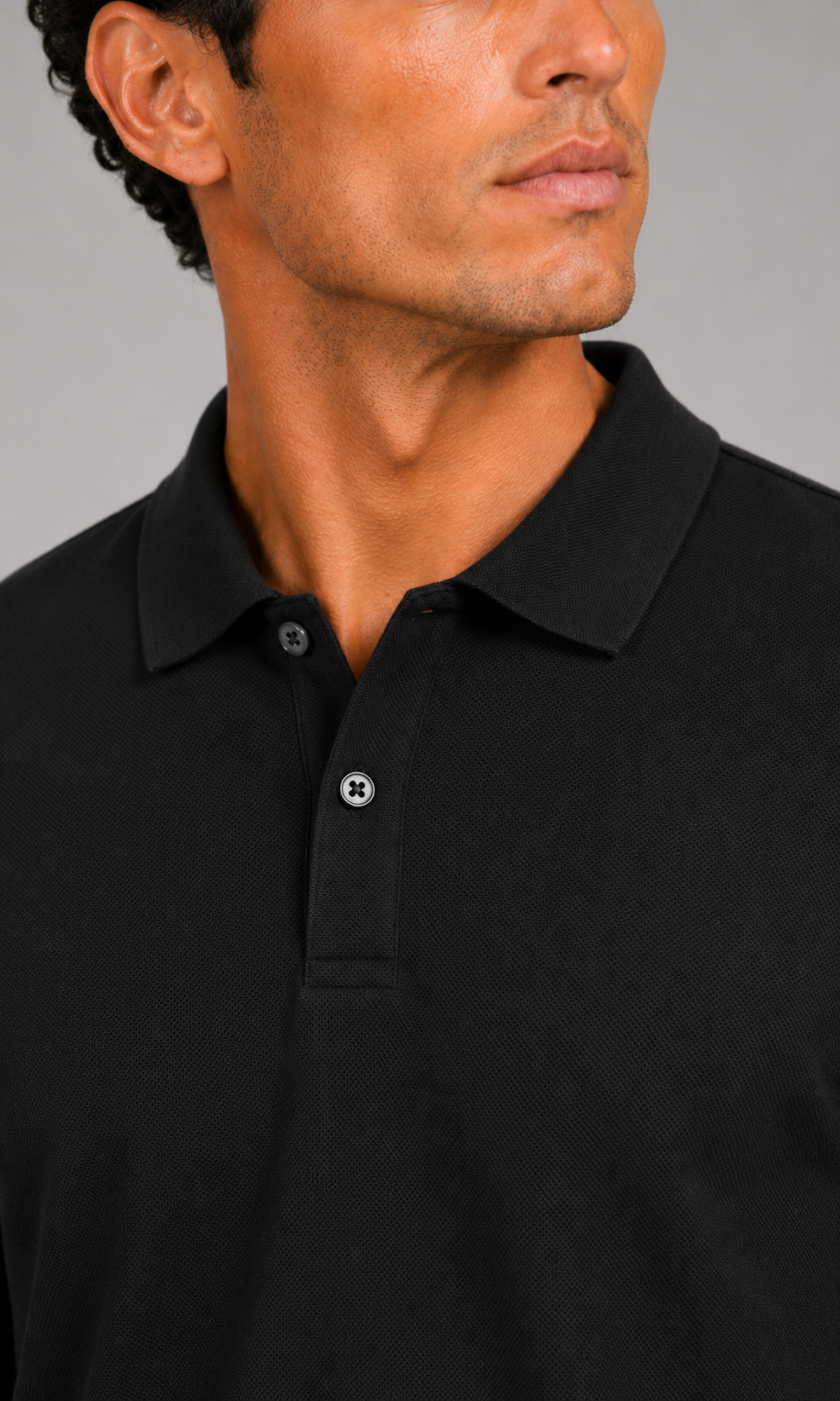 Close up of black polo shirt showing smooth silk touch fabric and refined collar detail