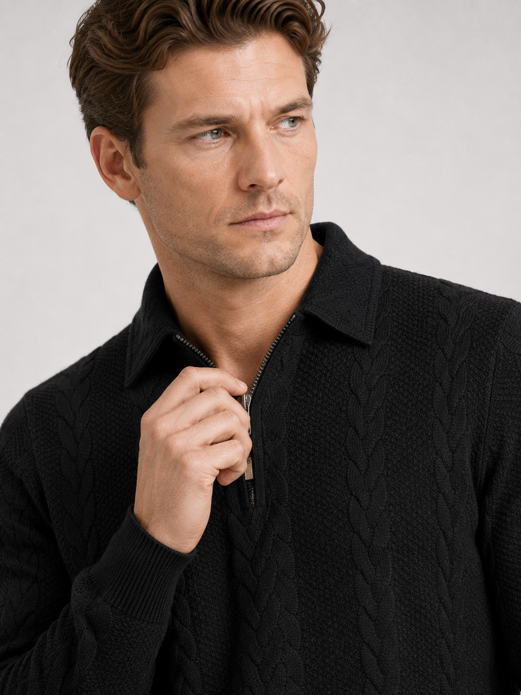 Close up of black quarter zip sweater showing soft knit texture, turn down collar, and zipper detail