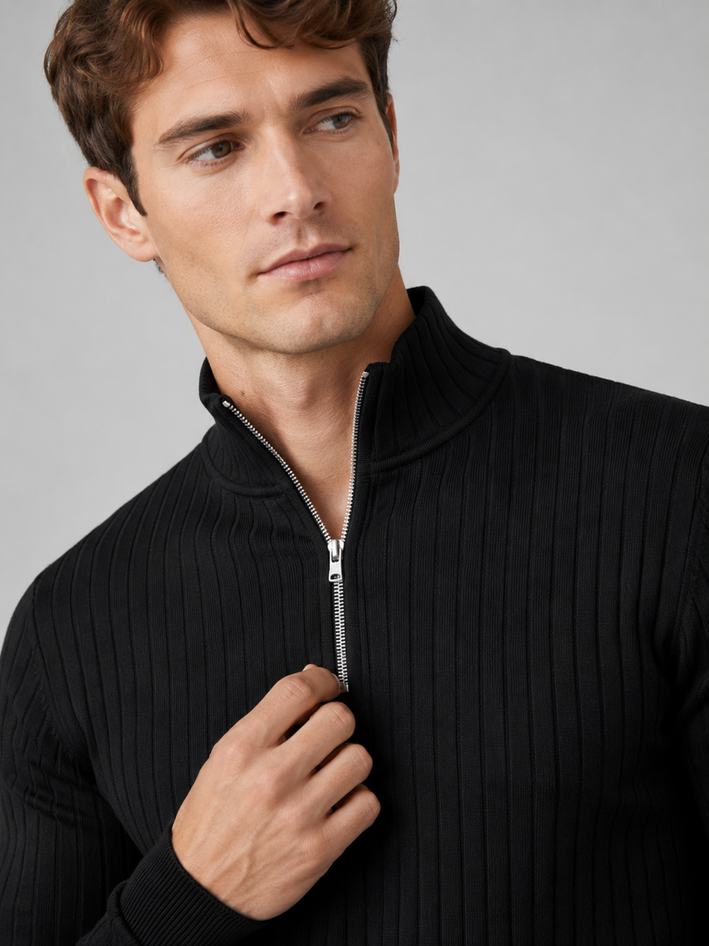 Close up of black quarter zip sweater showing soft knit texture and mock neck zipper detail