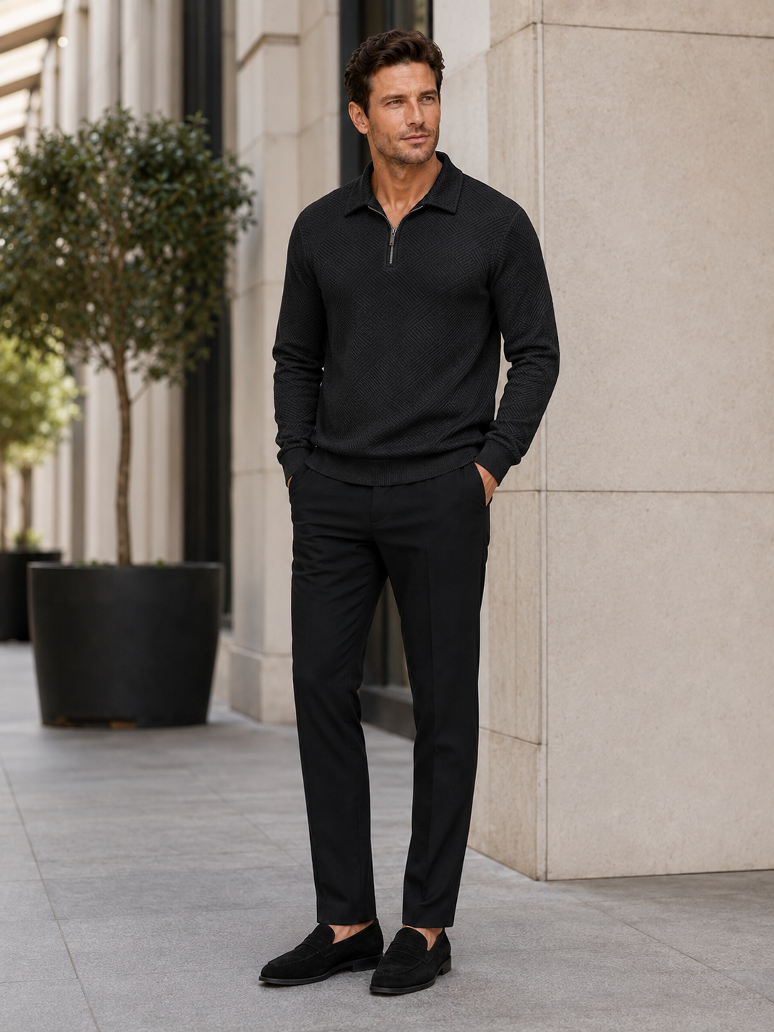 Man wearing a black lightweight quarter zip polo sweater in a modern business casual fall winter outfit