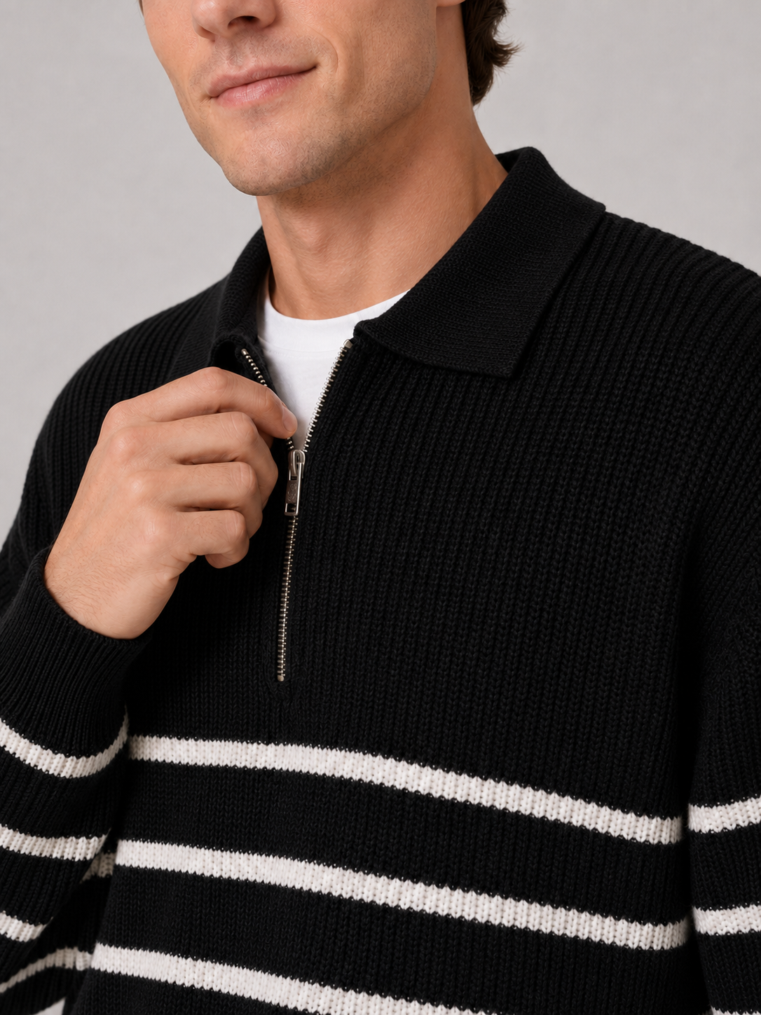Close up of black striped quarter zip sweater showing soft knit texture and zipper collar detail