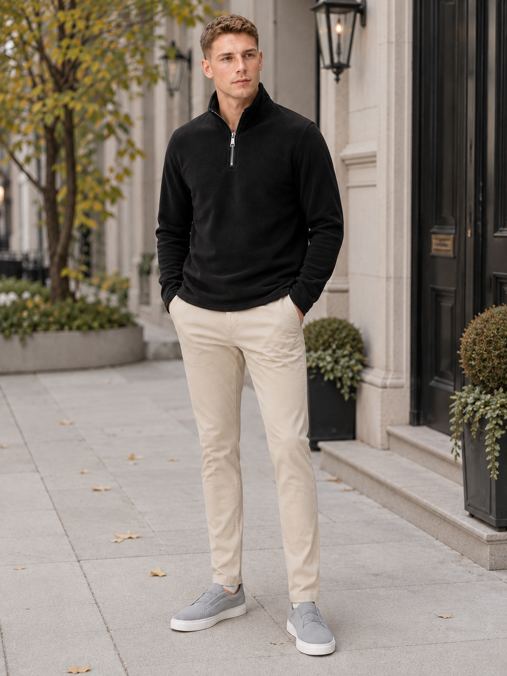 Man styling black quarter zip fleece sweater in a modern outdoor and winter lifestyle outfit