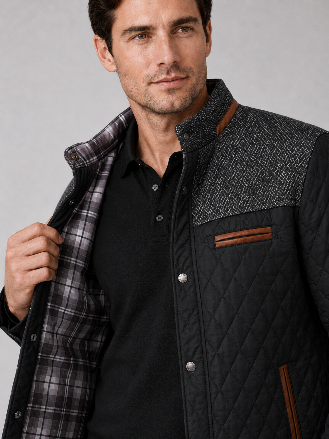 Close up of black quilted jacket showing diamond stitching and button down front detail
