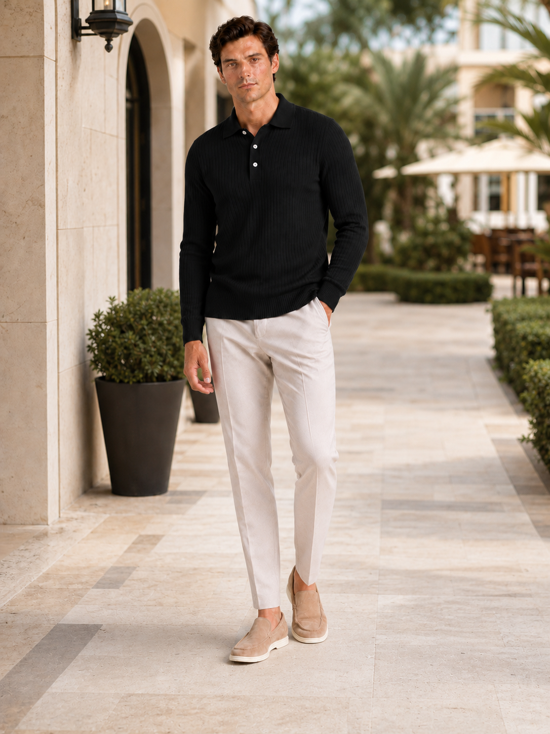 Man styling black ribbed long sleeve polo shirt in a modern business casual lifestyle outfit