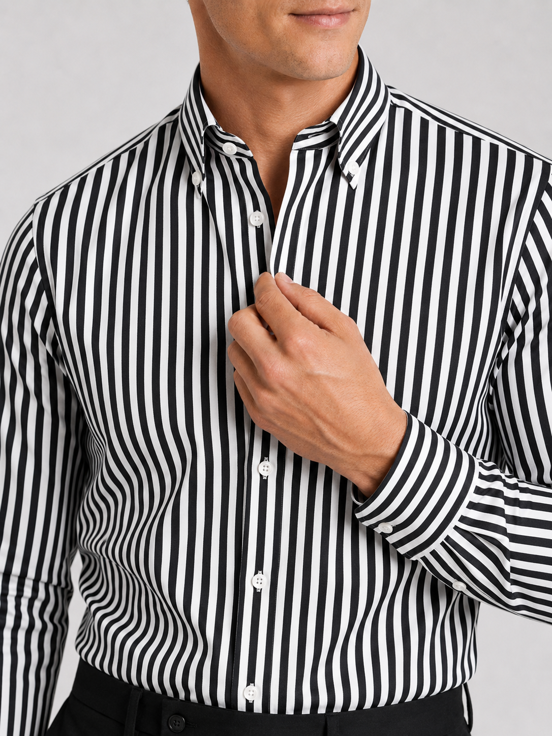 Close up of black striped dress shirt showing crisp fabric and refined collar detail