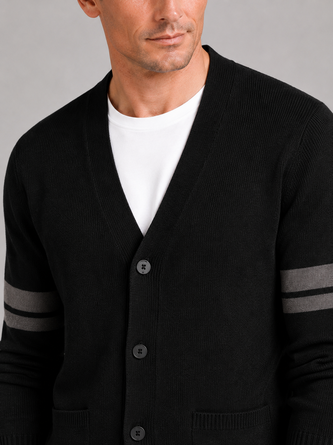 Close up of black striped cardigan showing soft knit texture and color block pattern detail