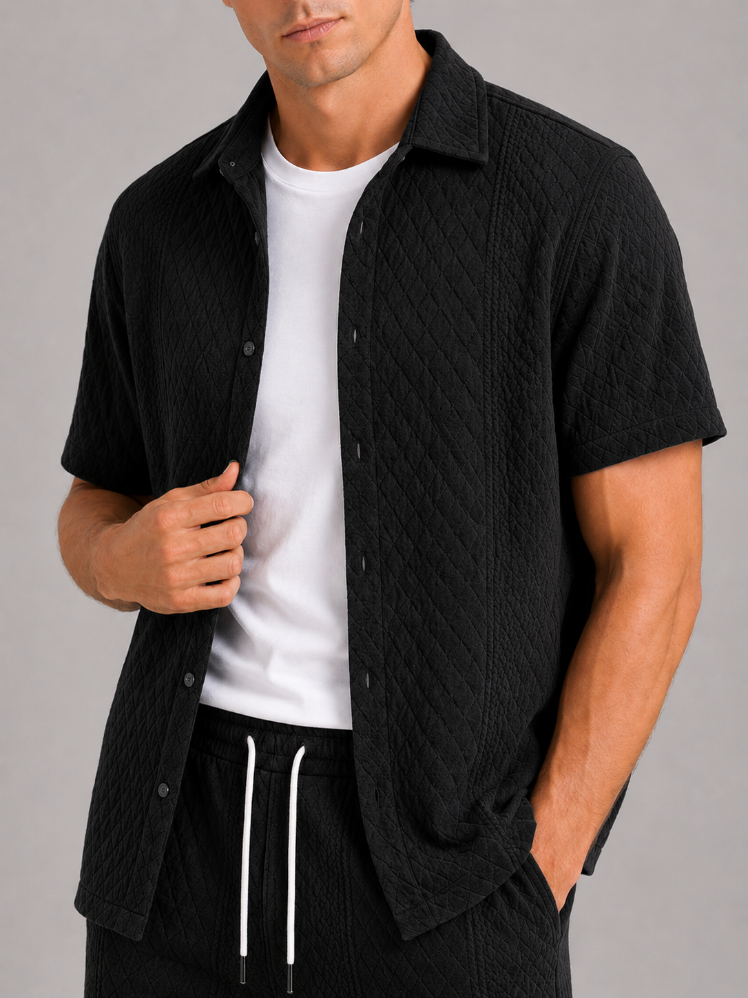 Close up of black textured two piece set showing lightweight fabric and woven texture detail