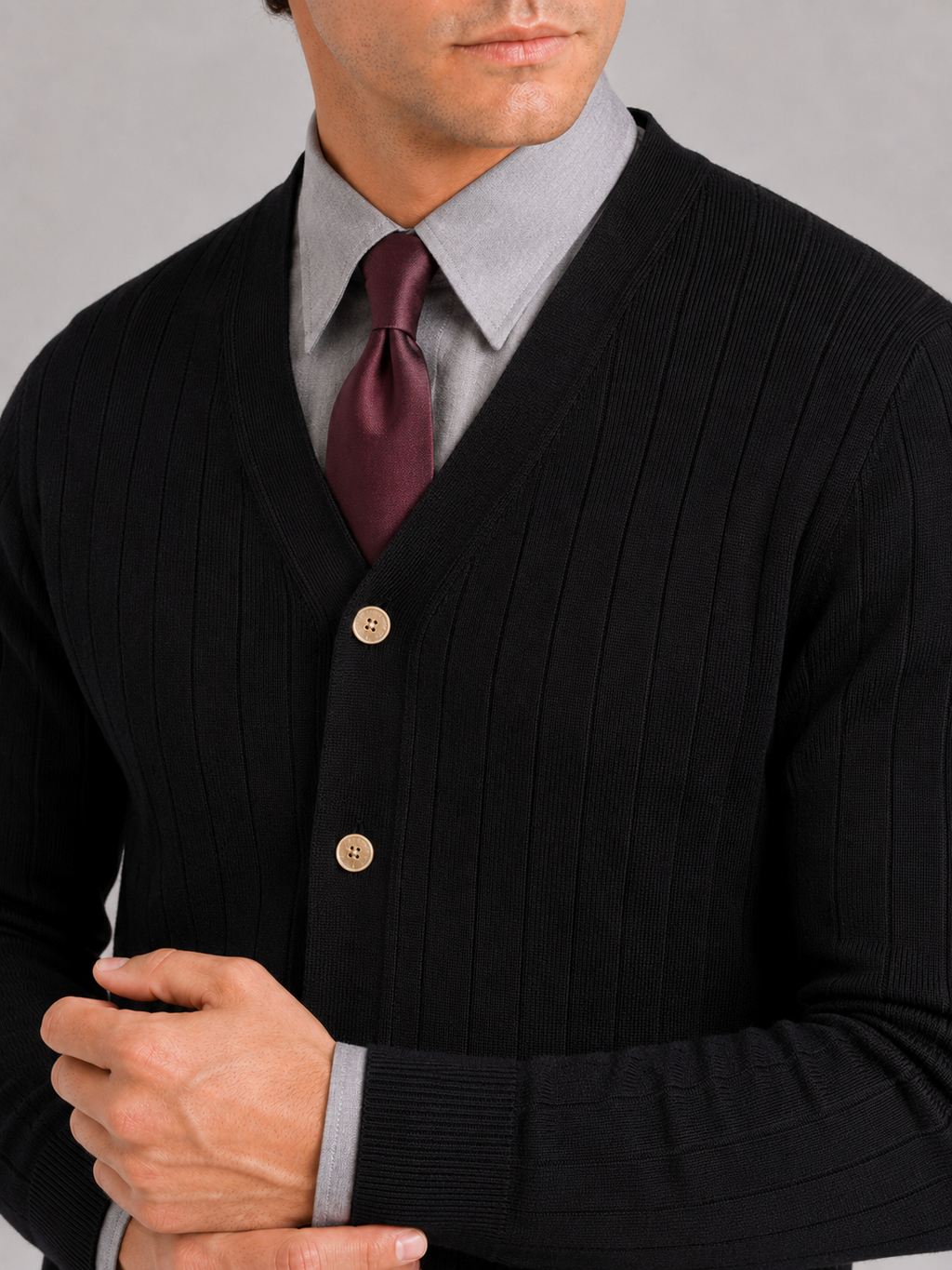 Close up of black knit cardigan showing soft lightweight texture and refined button front detail
