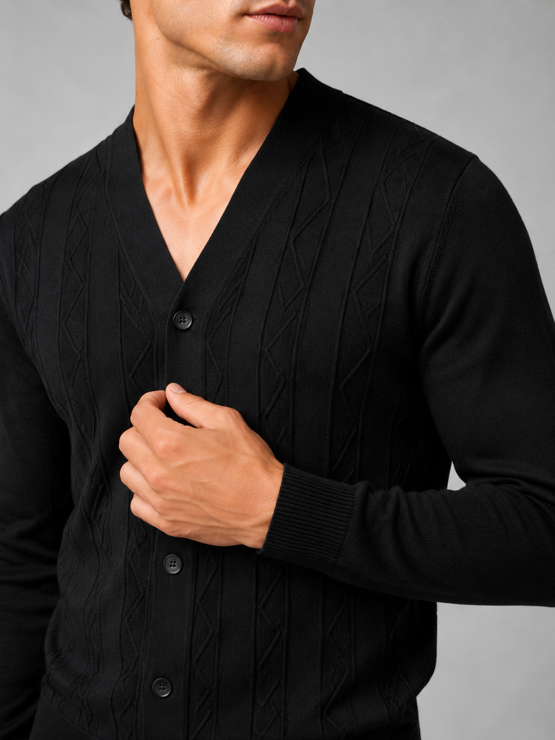 Close up of black knit cardigan showing soft lightweight texture and refined button front detail