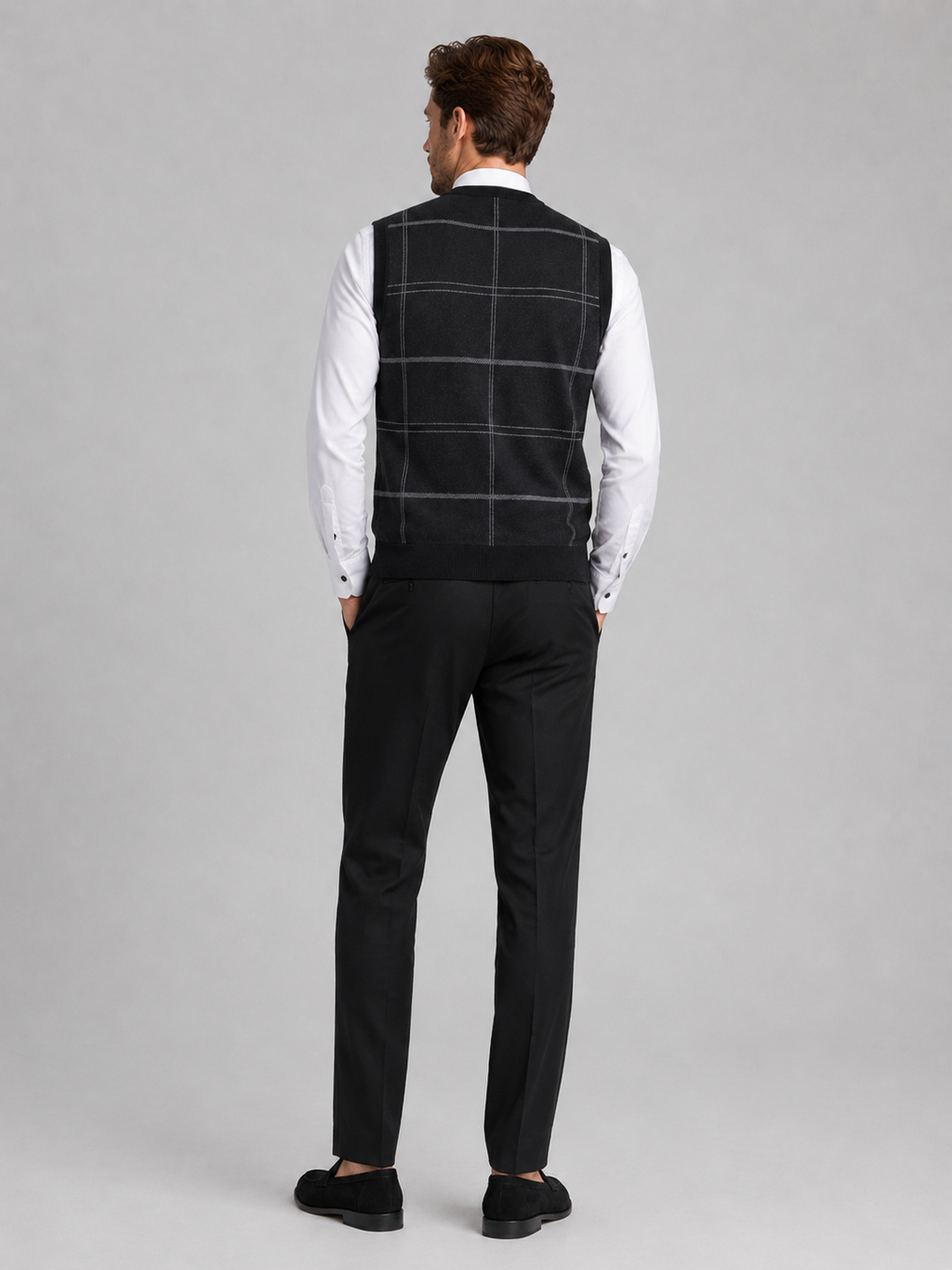 Back view of a man wearing a black V-neck sweater vest showing the sleeveless cut, warm knit fabric, and comfortable fit