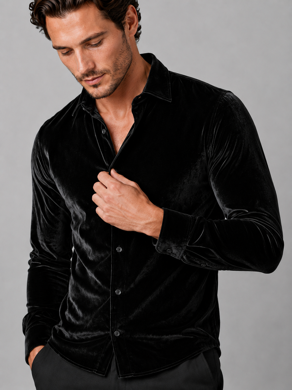Close up of black velvet shirt showing soft lustrous texture, lapel collar, and button front detail