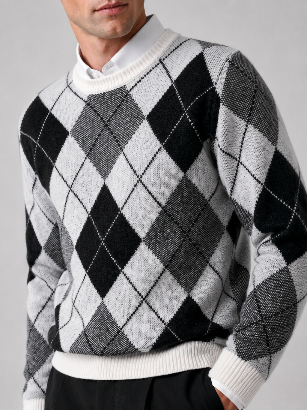 Back view of a man wearing a black wool argyle sweater showing the crew neck, long sleeves, thick knit fabric, and comfortable fit