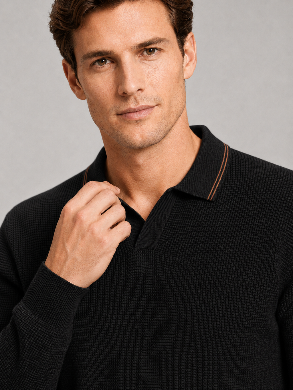 Close up of black wool polo sweater showing soft knit texture and refined Johnny collar detail