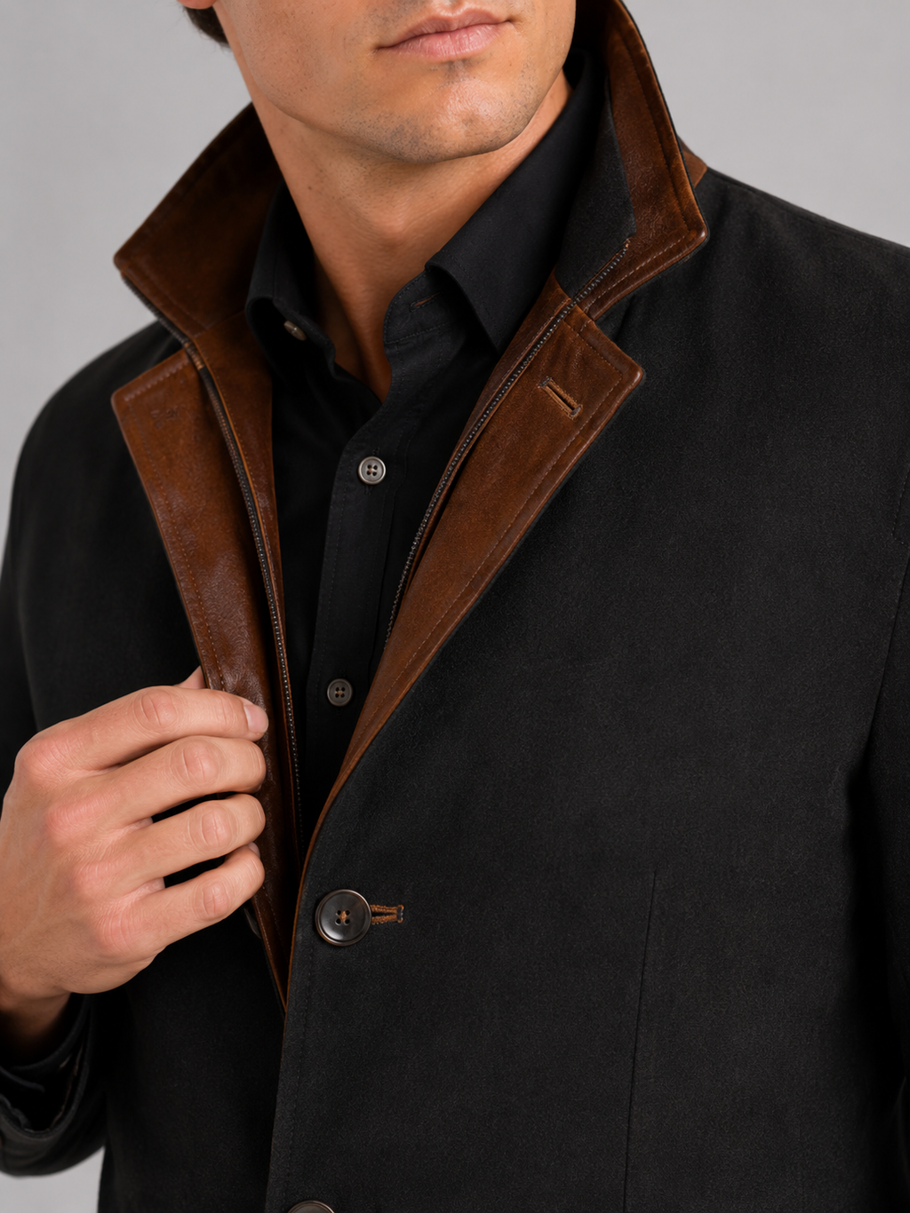 Close up of black workwear jacket showing contrast color details and durable fabric texture