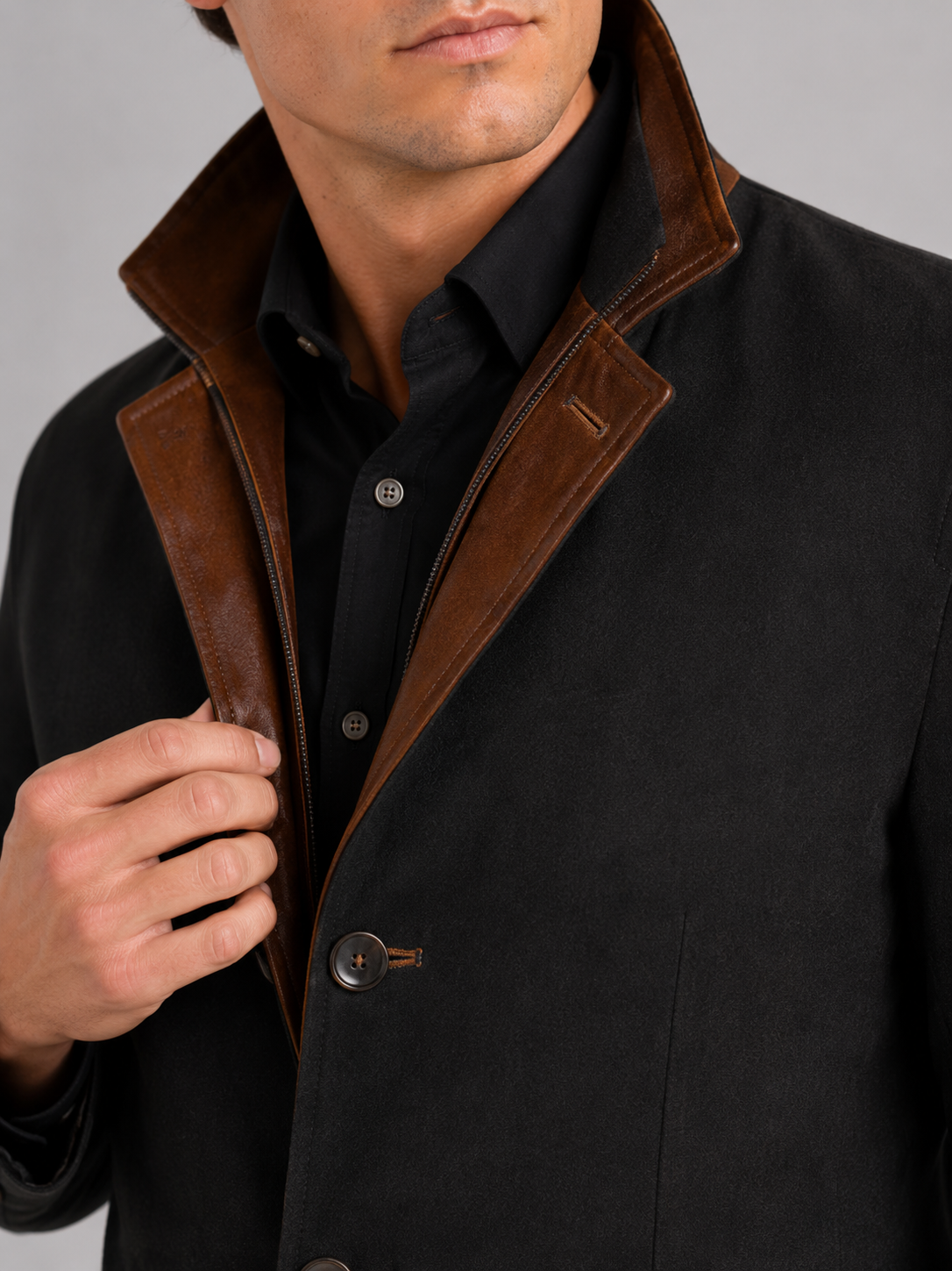 Close up of black workwear jacket showing contrast color details and durable fabric texture