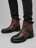 Man wearing black zip-up leather ankle motorcycle boots with black slim fit jeans in a casual fall winter streetwear outfit