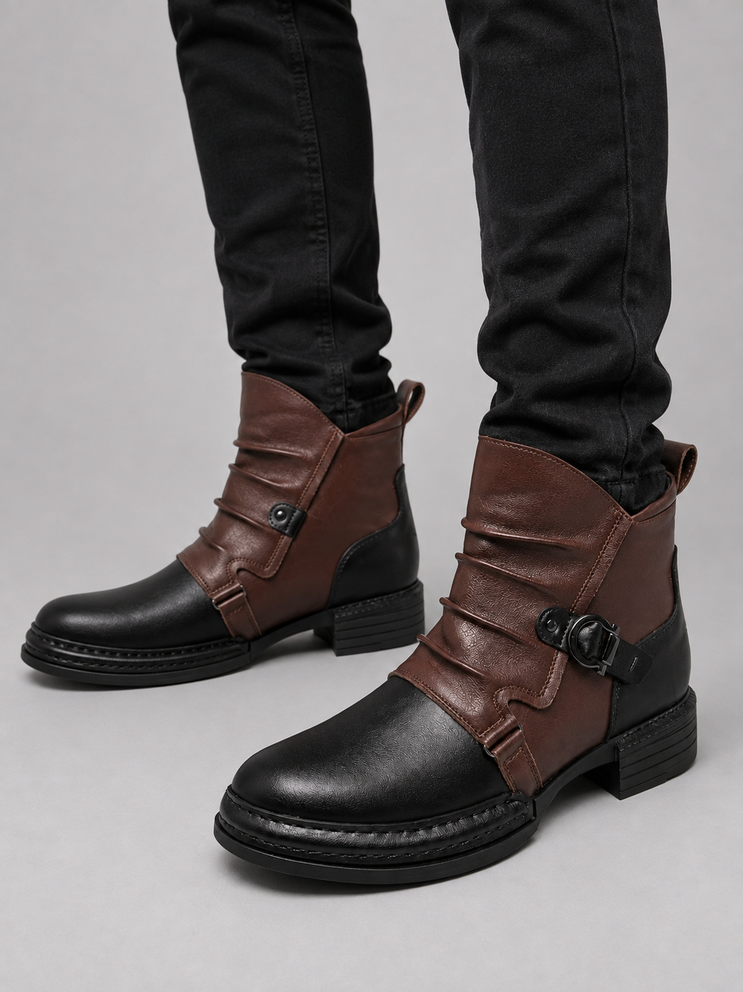 Man wearing black zip-up leather ankle motorcycle boots with black slim fit jeans in a casual fall winter streetwear outfit