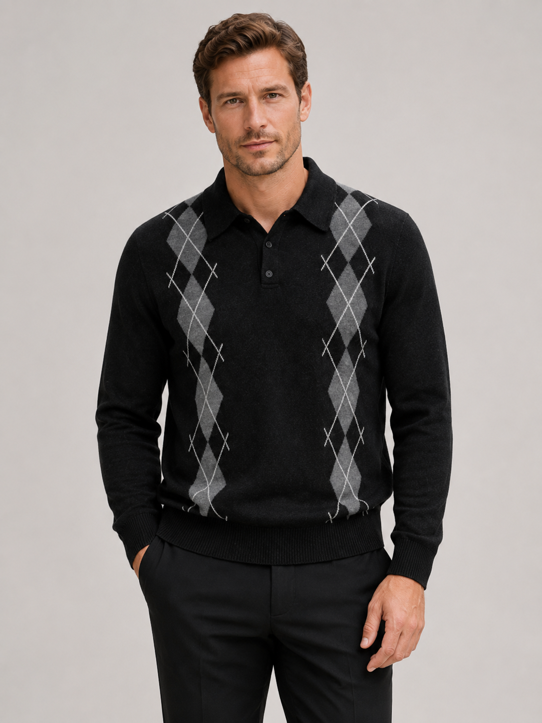 Front view of a man wearing a black argyle sweater with a contrast collar, long sleeves, and classic plaid knit pattern