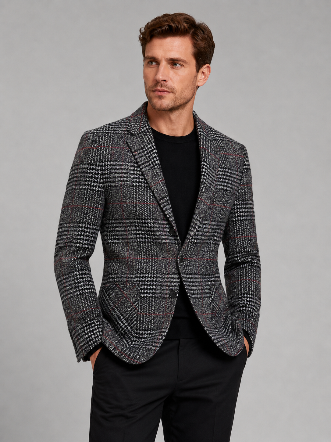 Front view of a man wearing a black checkered blazer with a slim fit, notched lapel, and tailored business casual design