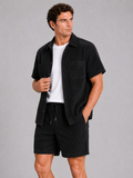 Men wearing black corduroy button up shirt and shorts set summer vacation outfit beach style