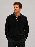 Front view of a man wearing a black corduroy long sleeve polo shirt with a contrast turn-down collar and relaxed fit