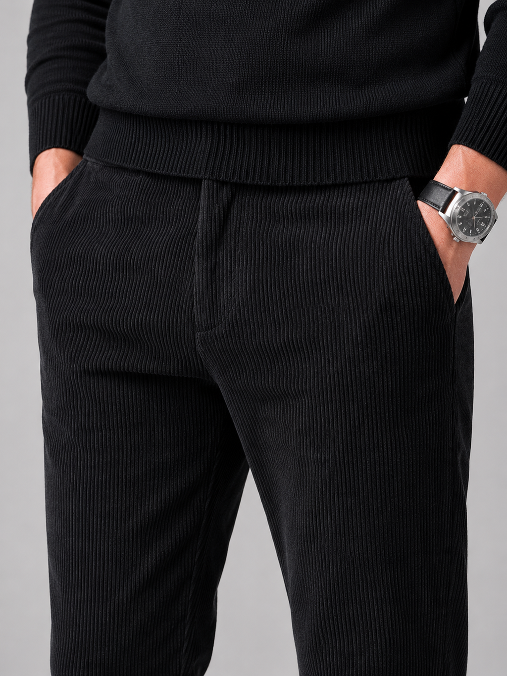 Close up of black corduroy pants showing soft ribbed texture and stretch fabric detail
