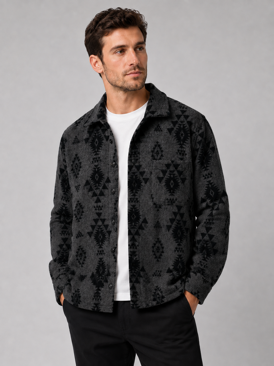Front view of a man wearing a black heavyweight flannel jacket with thick brushed fabric, button-up front, long sleeves, and warm wool-blend shacket design