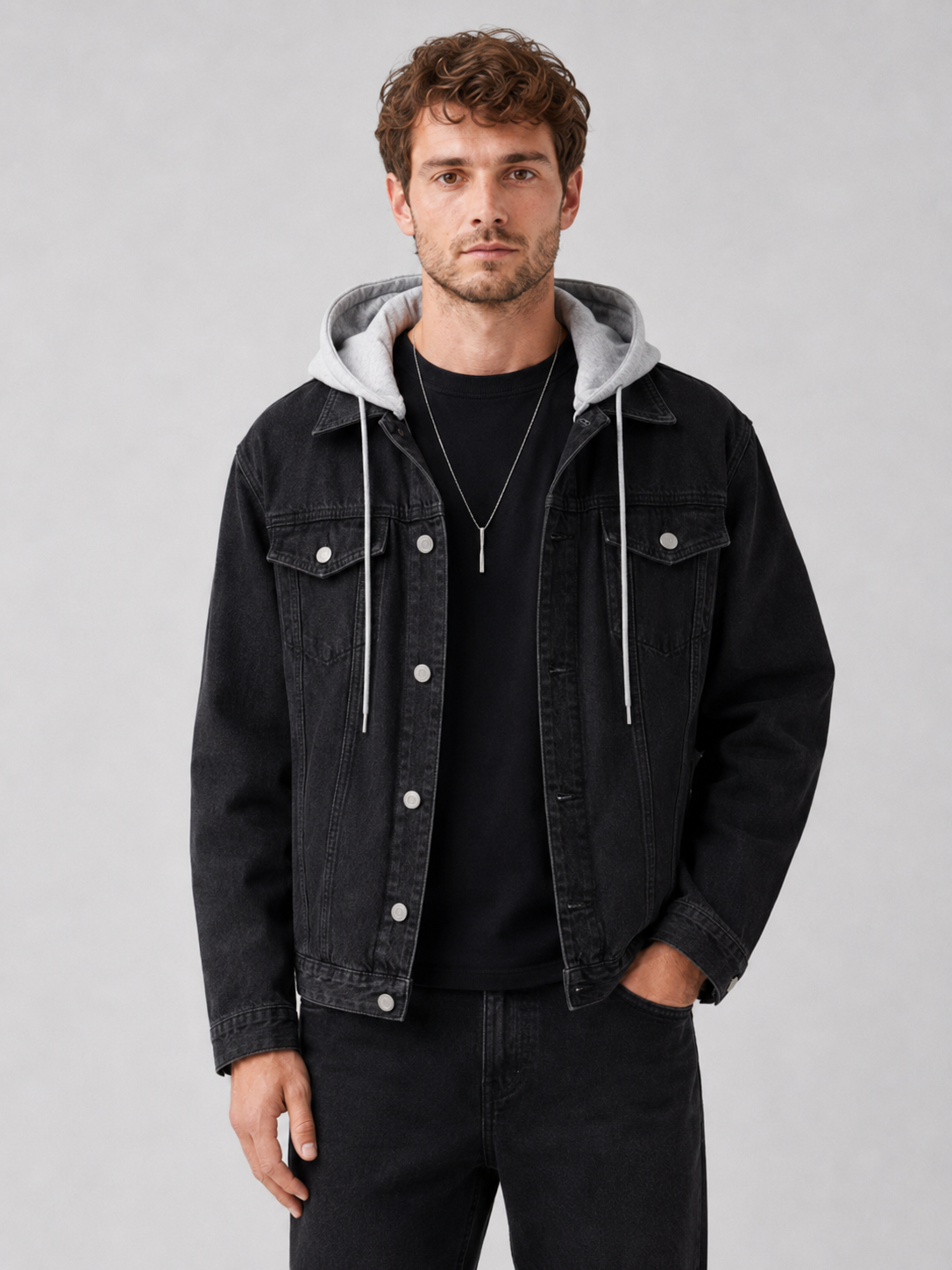 Men wearing black hooded denim jacket with detachable hood and loose fit winter streetwear style