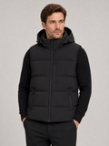 Front view of a man wearing a black hooded puffer vest with a windproof shell, thick insulation, sleeveless design, and full zip front