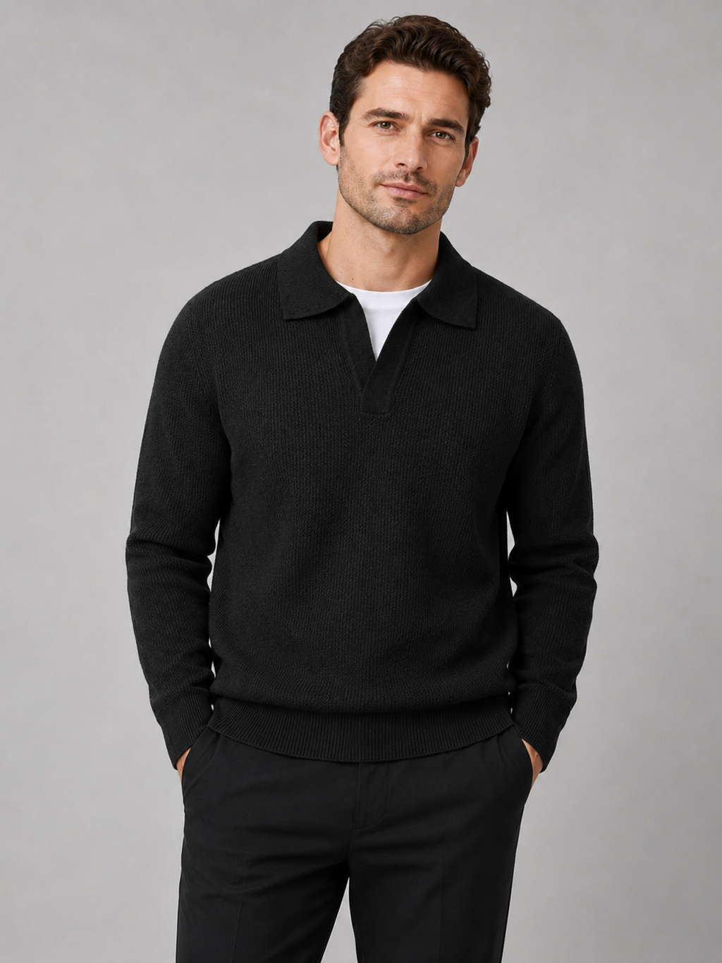 Front view of a man wearing a black heavyweight knit Johnny collar sweater with long sleeves