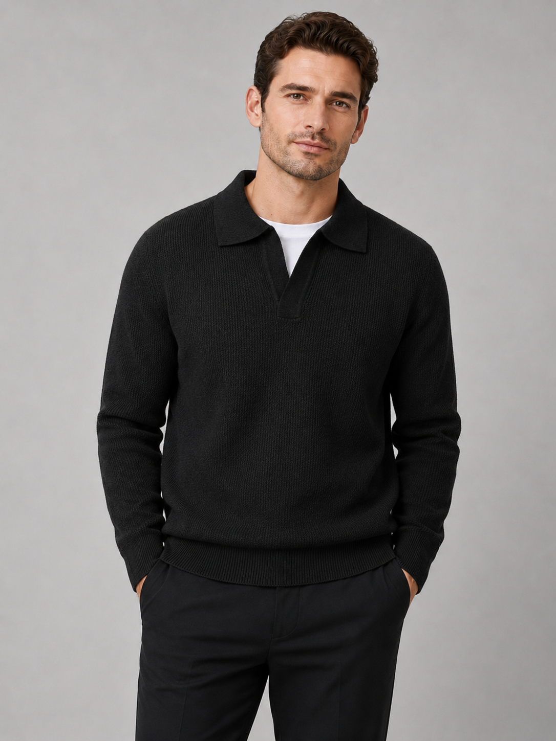 Front view of a man wearing a black heavyweight knit Johnny collar sweater with long sleeves
