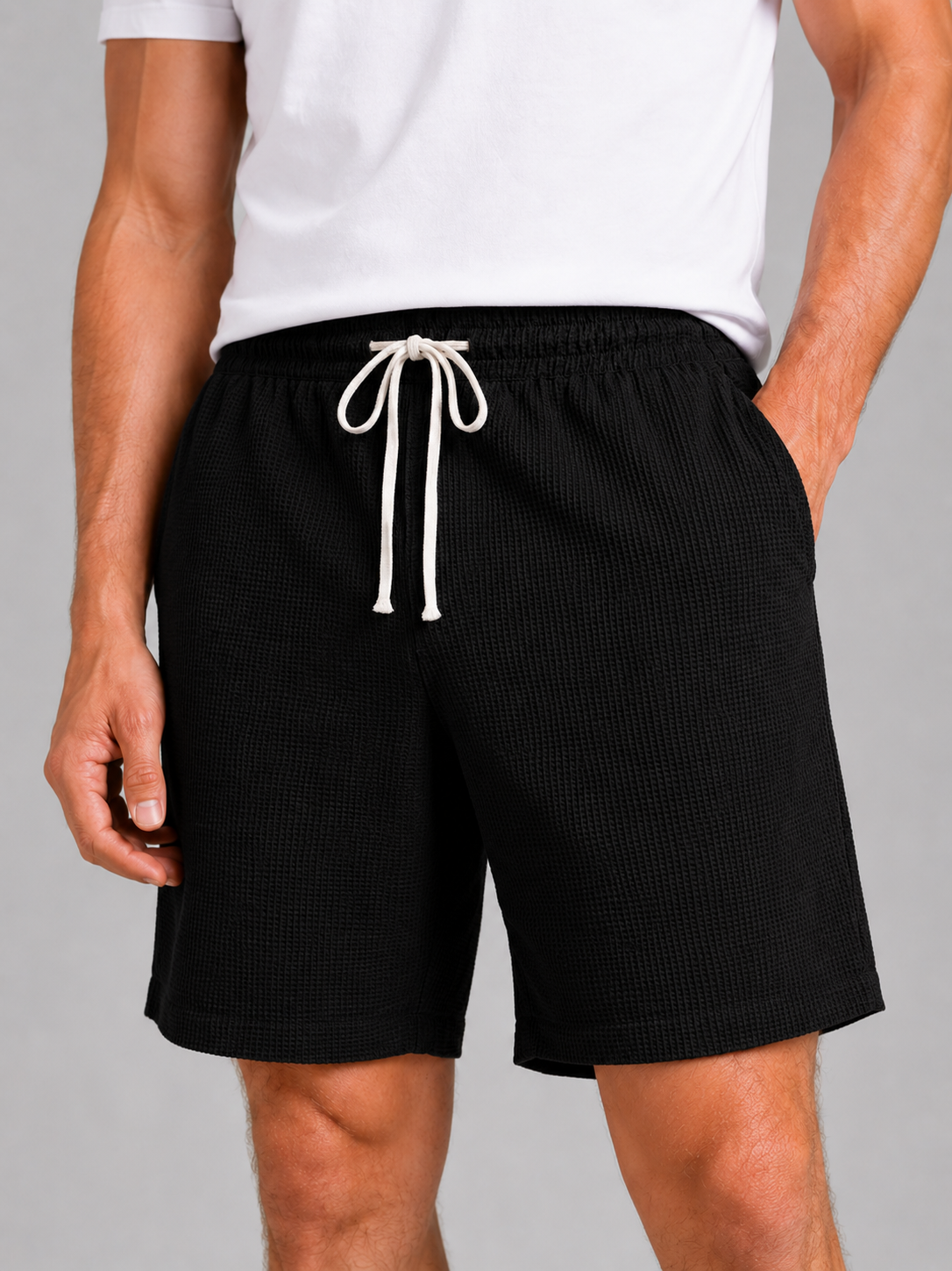 Close up of black waffle texture shorts showing breathable fabric and adjustable drawstring waistband