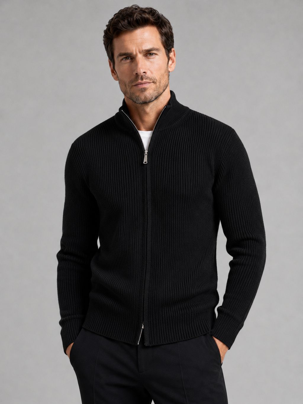 Front view of a man wearing a black ribbed knit cardigan sweater with a full zip front, stand collar, slim fit, and long sleeves