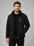 Front view of a man wearing a black polar fleece jacket with a windproof design, full zip front, stand collar, and thick warm construction