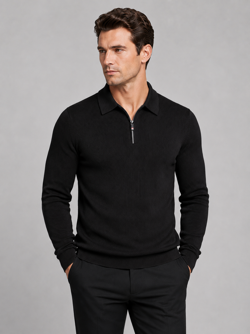 Front view of a man wearing a black quarter zip long sleeve polo with a lapel collar and tailored business casual fit