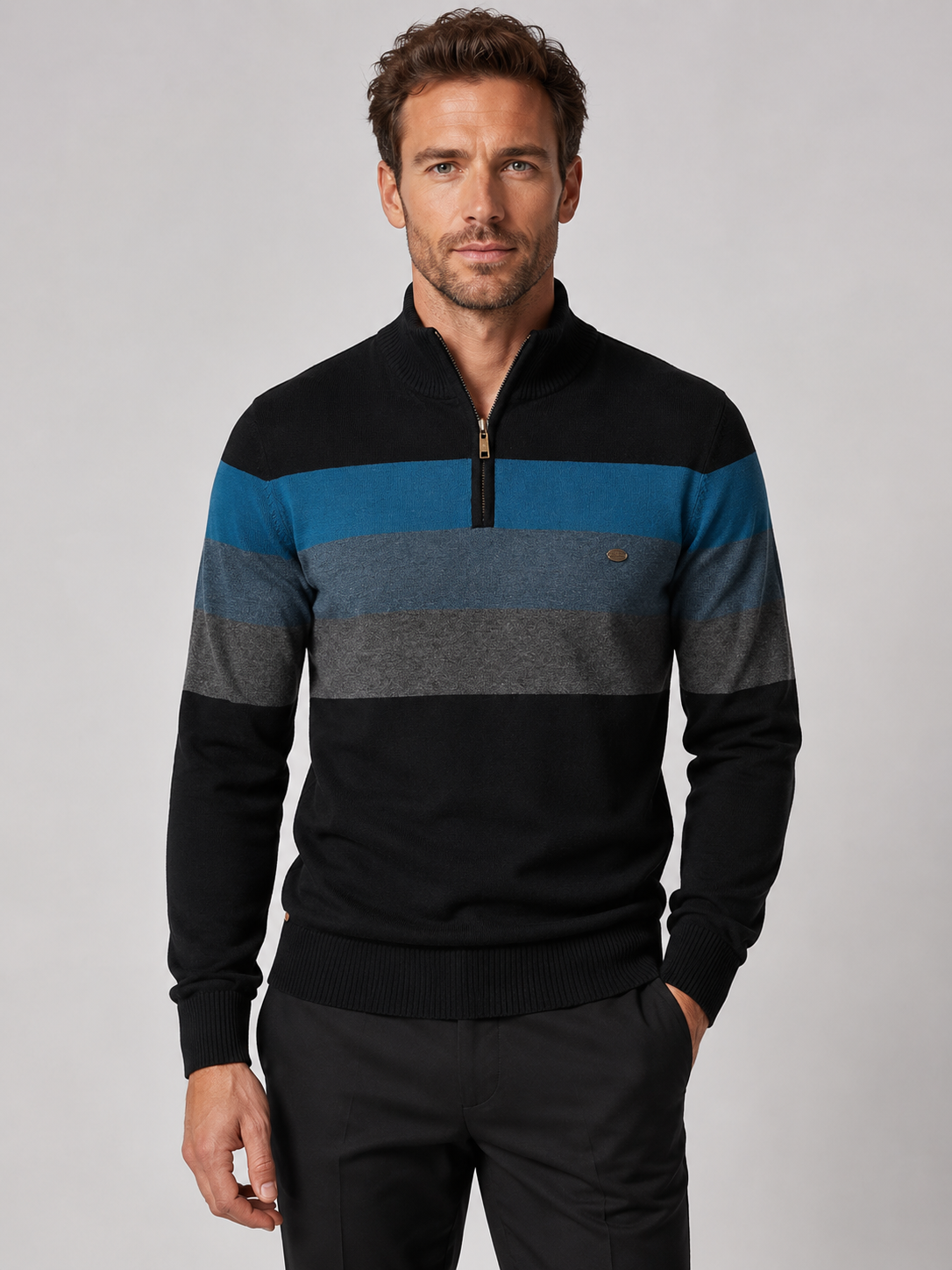 Front view of a man wearing a black patchwork cotton quarter zip sweater with a mock neck and long sleeves