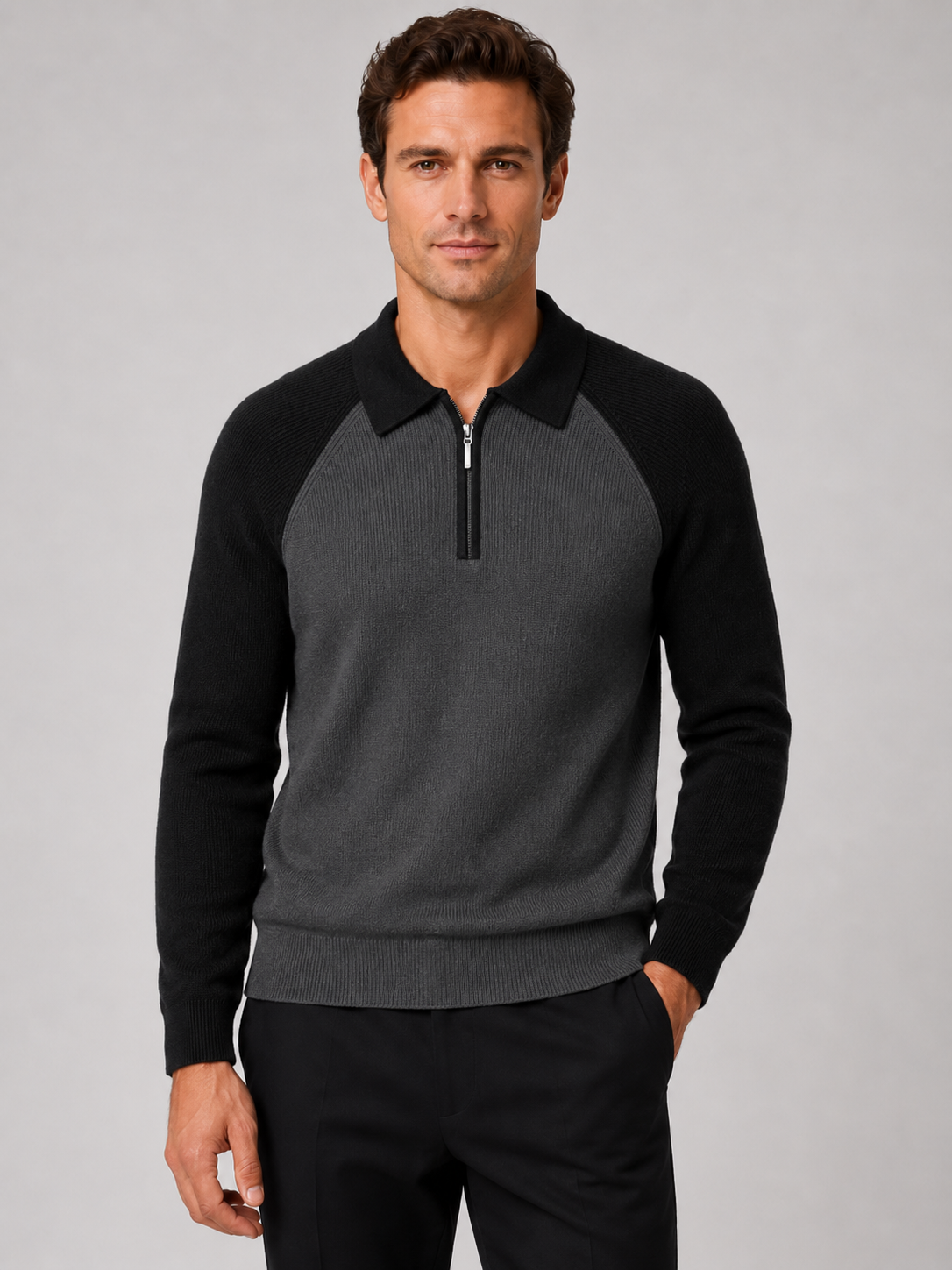 Front view of a man wearing a black slim fit quarter zip polo sweater with long sleeves and a knit collar