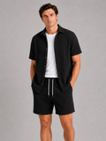 Men wearing black textured summer matching set short sleeve two piece outfit vacation style
